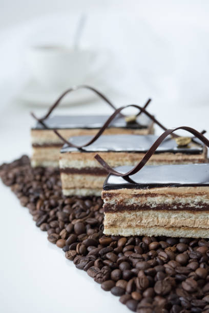 Chocolate cake on coffee beans on white table