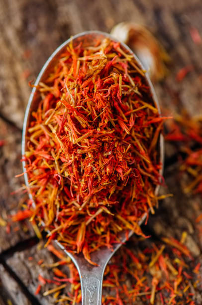istock Dried saffron spice in a spoon on a wooden background. 969450102