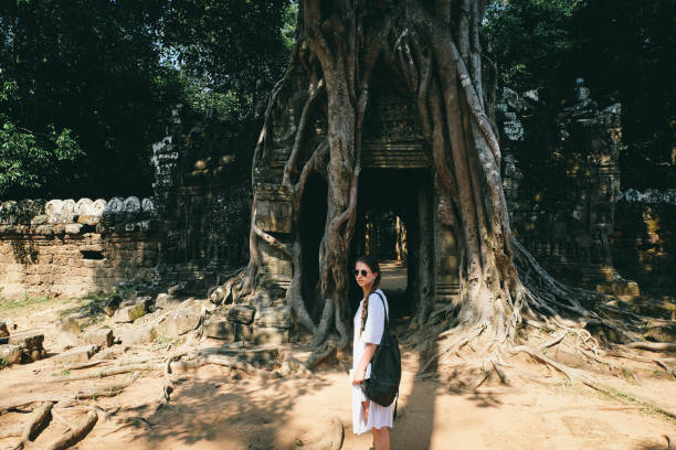 istock Woman with backpack exploring Angkor in Cambodia 969452380