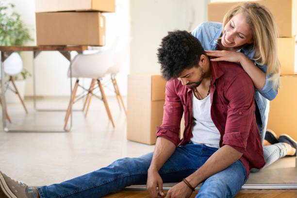 istock Tired couple with boxes moving into new home 969456212