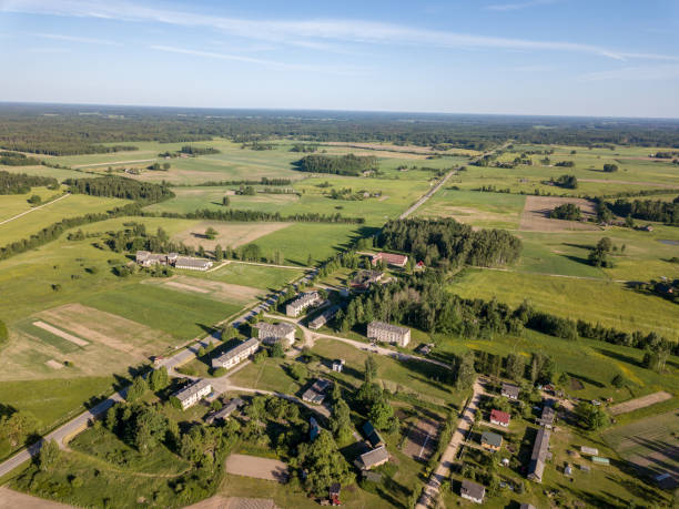 istock drone image. asphalt road surrounded by pine forest and fields from above 969457856
