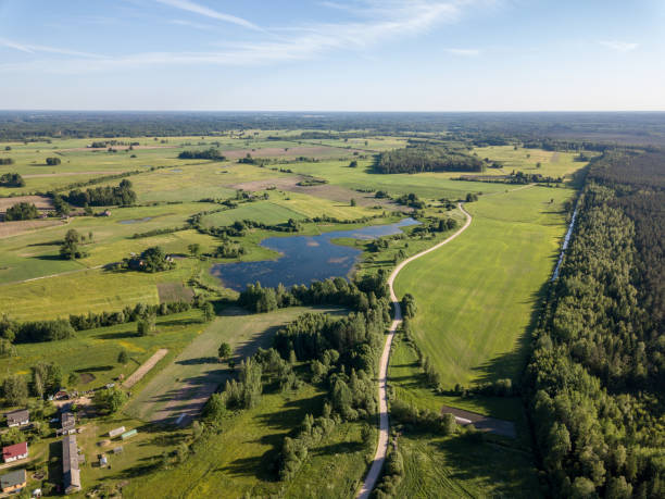 istock drone image. aerial view of countryside road network, cultivated fields and forest textures 969457860