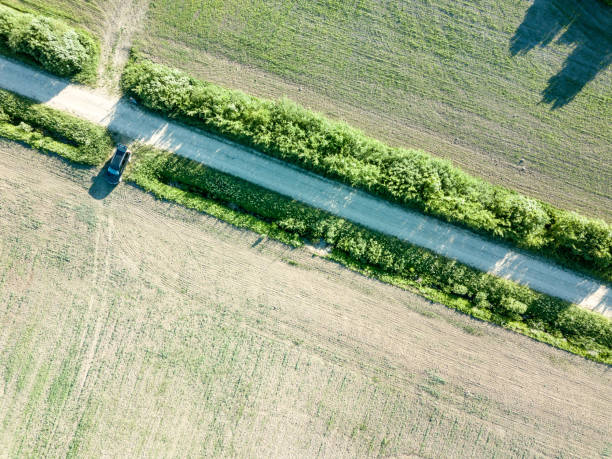 istock drone image. aerial view of countryside road network, cultivated fields and forest textures 969460888