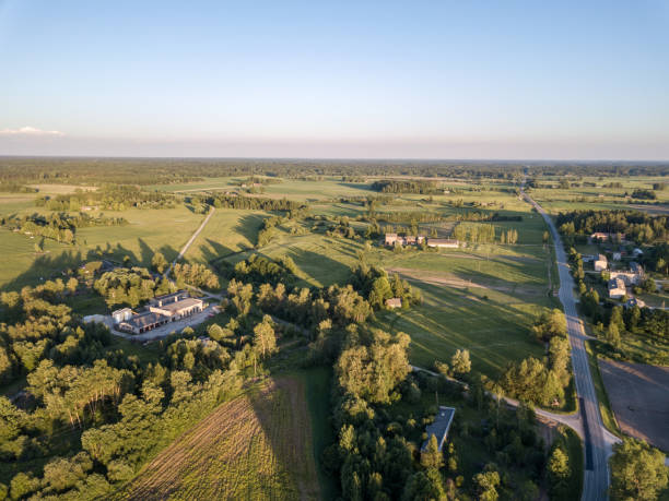 istock drone image. aerial view of countryside road network, cultivated fields and forest textures 969461334
