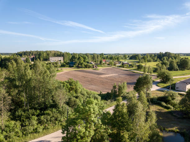 istock drone image. aerial view of countryside road network, cultivated fields and forest textures 969461370
