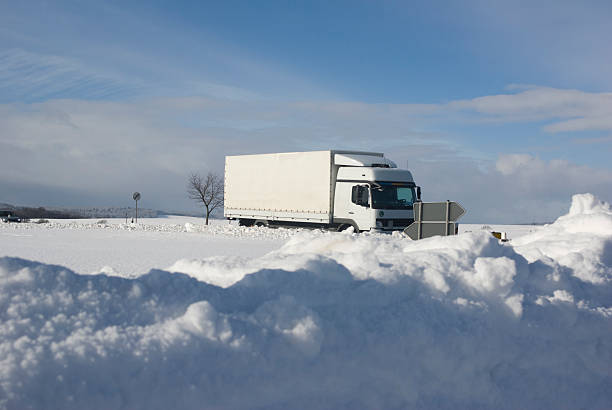 istock White truck driving on a wintry road 96947248