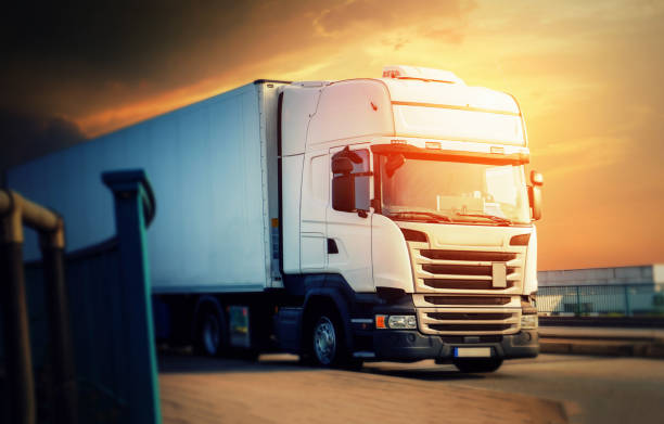istock White truck at sunset comes from the highway 969473116