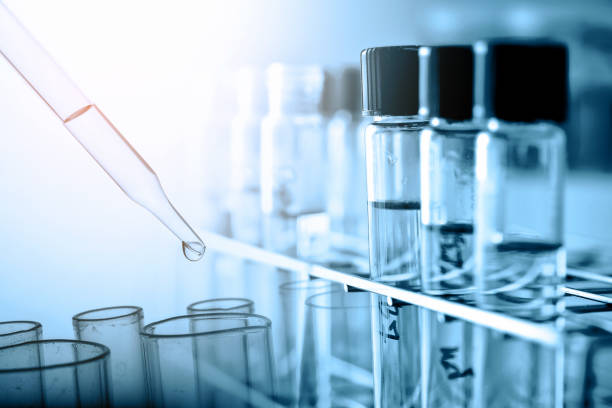 istock Dropping Chemical liquid to test tube with lab glassware, science research and development concept 969473522