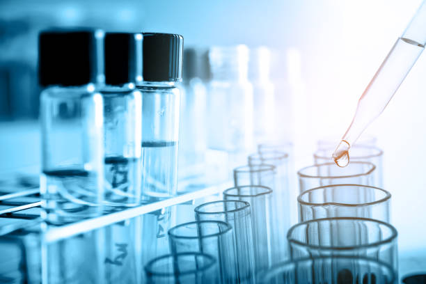 istock Dropping Chemical liquid to test tube with lab glassware, science research and development concept 969473534