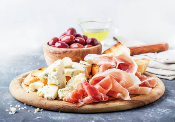 istock Board with appetizers, crostini, prosciutto, blue cheese and olives 969476766