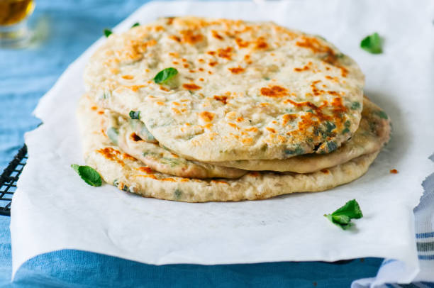 istock Indian flatbread - Herb stuffed paratha on a baking paper 969477132
