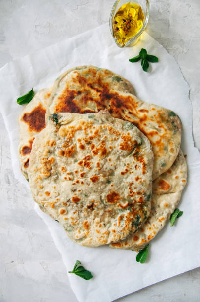 istock Indian flatbread - Herb stuffed paratha on a baking paper 969477146