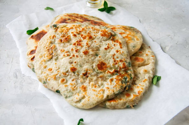 istock Indian flatbread - Herb stuffed paratha on a baking paper 969477168