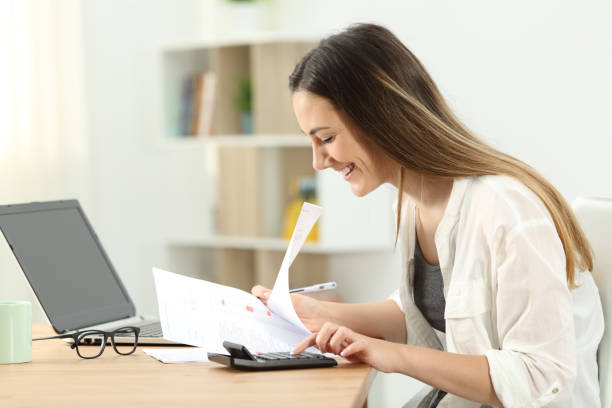 istock Happy woman doing accounting at home 969477308