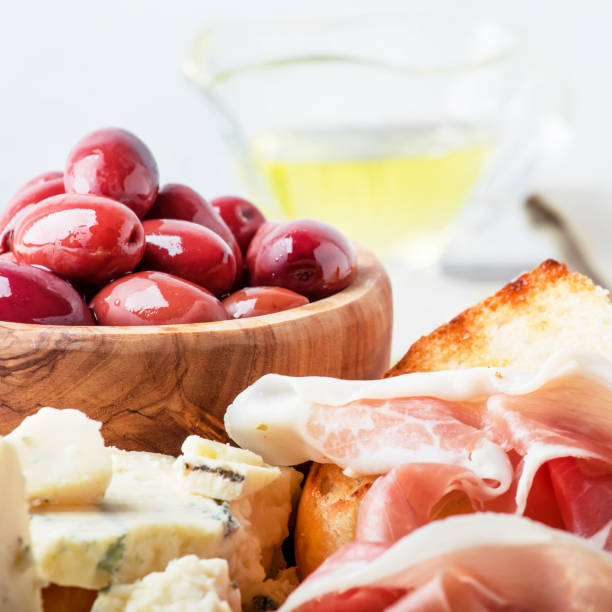 istock Board with appetizers, crostini, prosciutto, blue cheese and olives 969477800