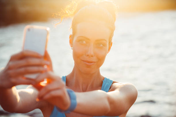istock Sportswoman taking selfie at the beach 969481080