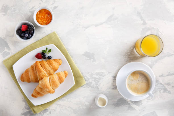 istock Breakfast served with croissants, coffee, orange juice and berries. Copy space. Top view. 969485378