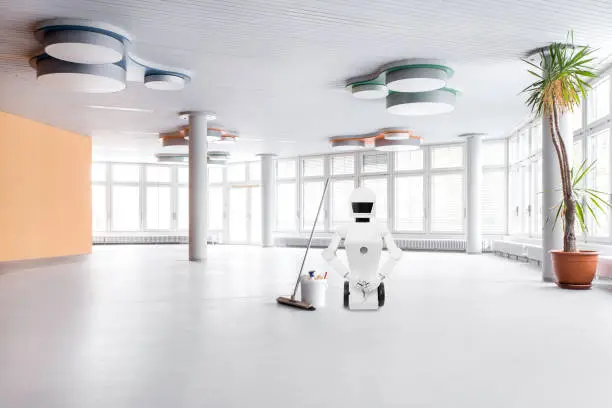 cleaning service roboter in the middle of a big hall, is doing his cleaning work with a broom