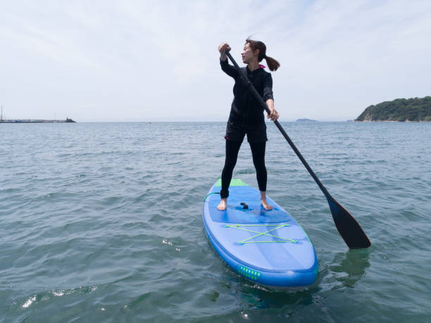 istock A woman riding hard on the suppor board. 969490076