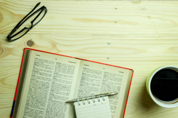 istock An Open Book with an Eyeglasses and a Cup of Coffee on the Table 969492854