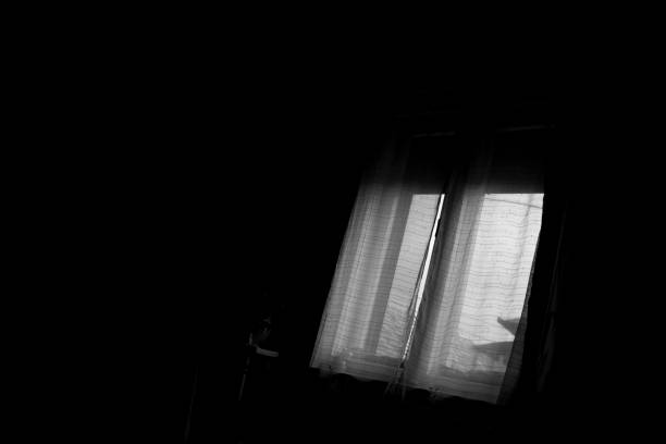 istock window in the dark room 969492988