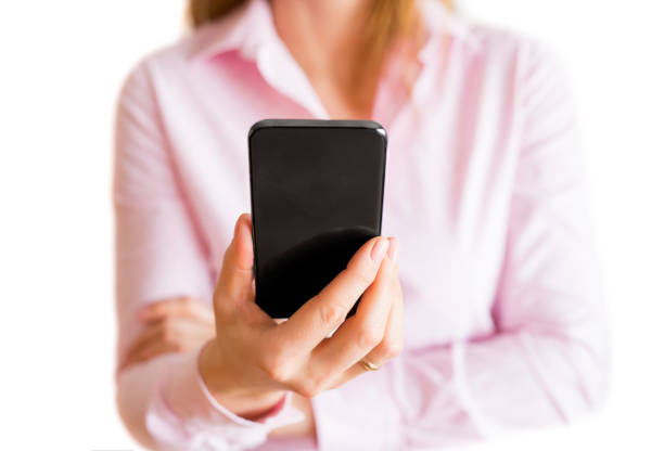 Unrecognizable woman looking at her mobile phone. Isolated on white background.