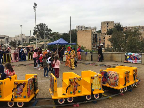 Riad Al Fath, Algiers, Algeria - April 7, 2018: Algerian children with clowns in playground.