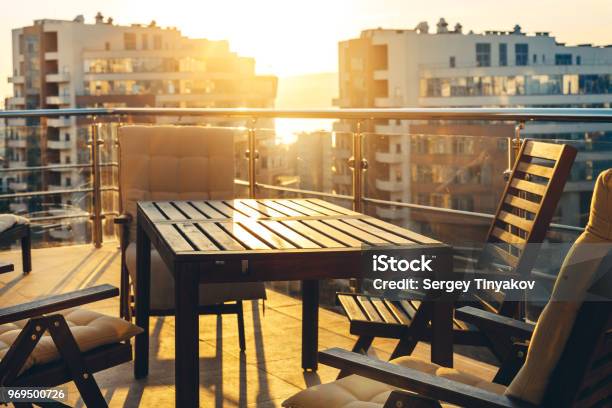 Outdoor Terrace With Garden Furniture In The Background Of The City And Sunset Luxury Apartments Resort Recreation Summer Concept Stock Photo - Download Image Now
