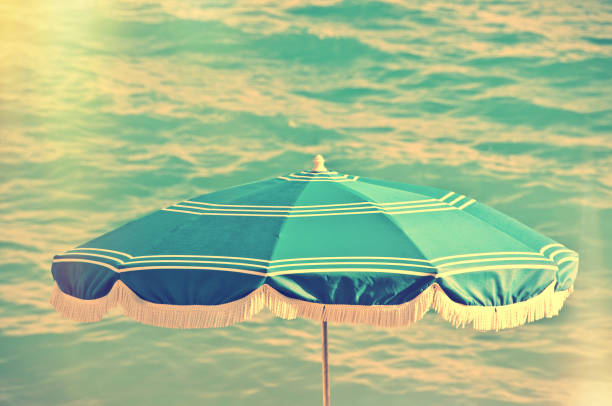 Beach umbrella, sea background, vintage summer concept