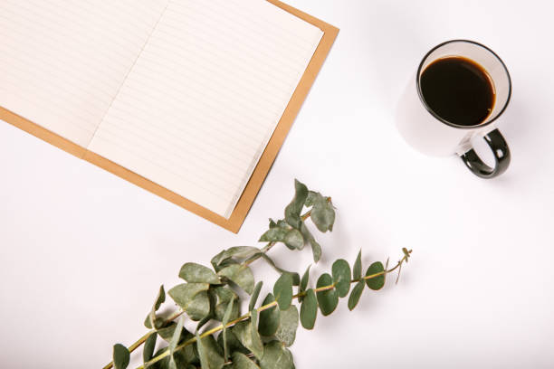 istock Blank notebook with cup of coffee and flowers 969504838