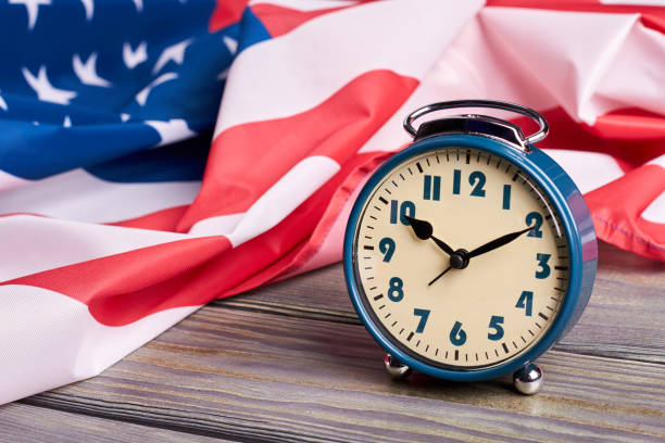 istock USA flag and alarm clock. 969507202