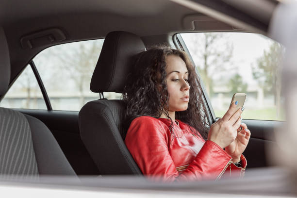 istock Brunette with phone at steering wheel 969507596