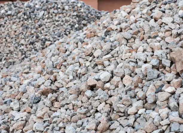 Piles of granite rocks at construction site, selective focus