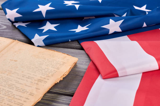istock Folded flag of USA and old book. 969510066