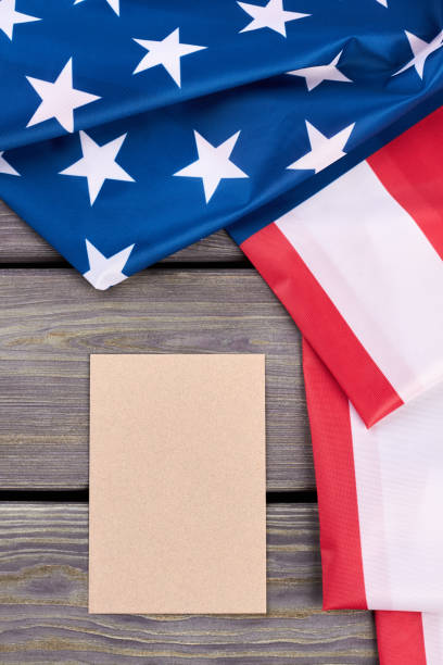 istock American flag and blank paper sheet. 969510146