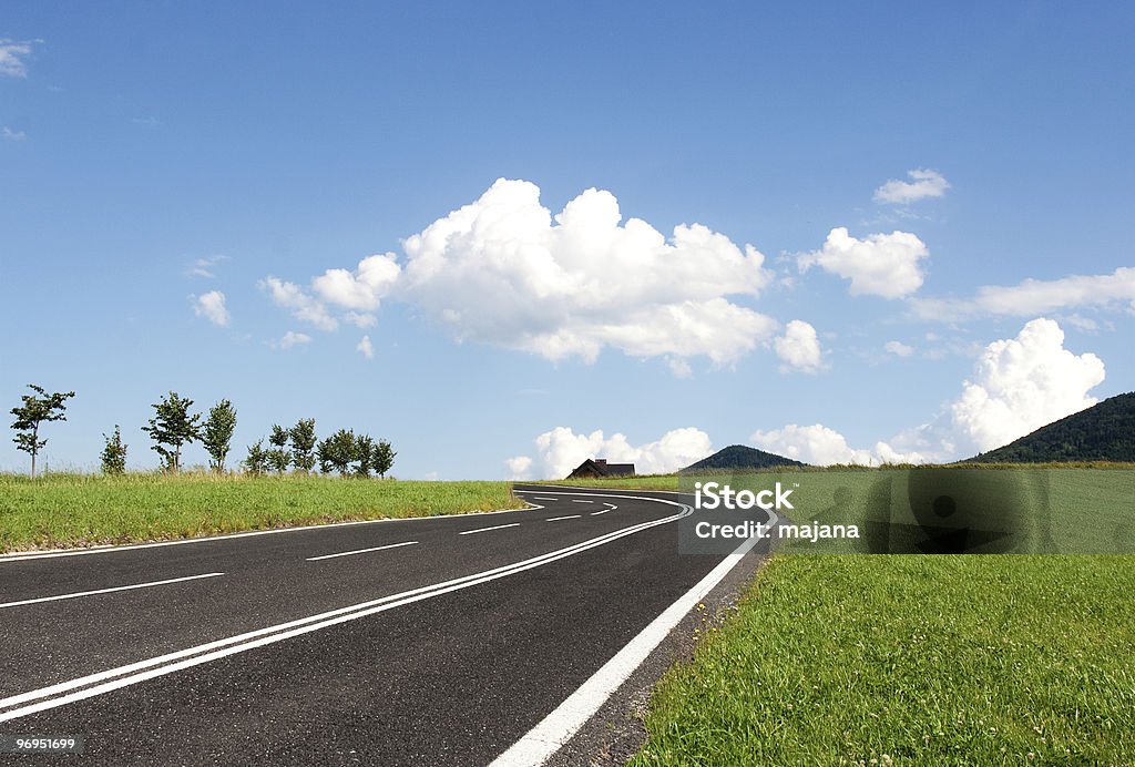 Rendered graphic of new road traversing a green field Road winding into the hills Cloud - Sky Stock Photo