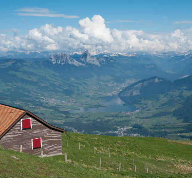 House on mountainside overlooking alps