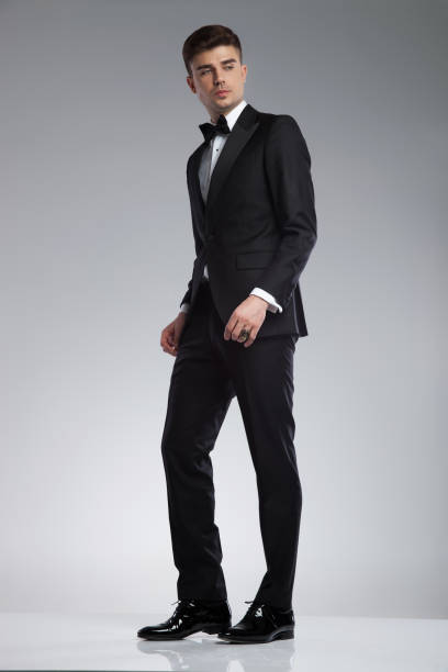 istock young man in tuxedo standing and looking down to side 969519772