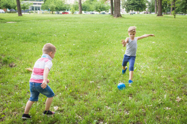 istock Small boys playing with ball on the park. 969522418