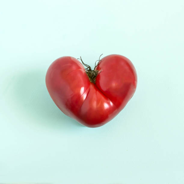 Tomato in shape of heart stock photo