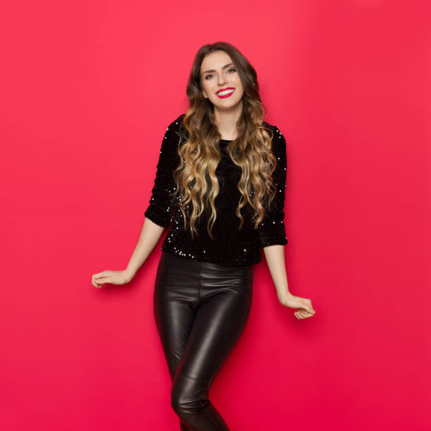 istock Beautiful Smiling Woman In Black Sequin Sweater 969528580