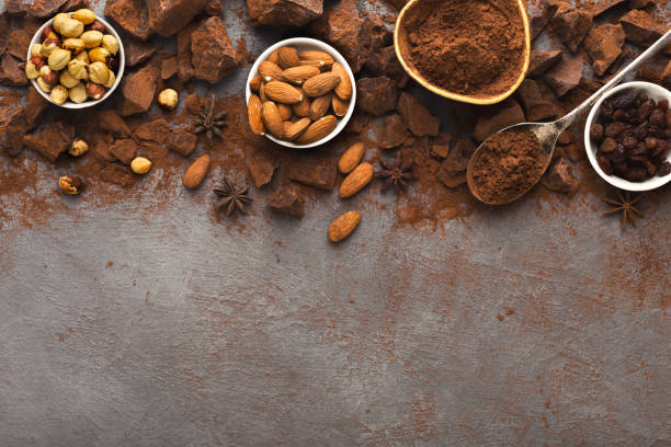 istock Crushed chocolate bar pieces and cocoa on gray background, top view 969531280