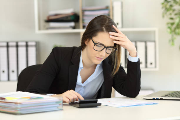 istock Worried bookkeeper calculating expenses at office 969531482