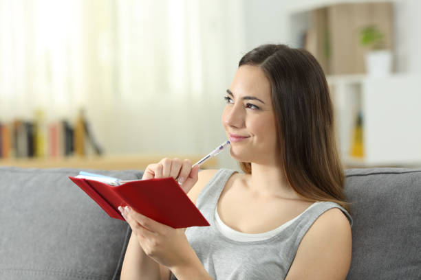 istock Woman thinking ready to take notes in an agenda 969531508