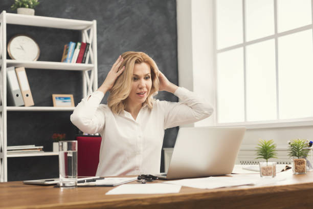 istock Surprised businesswoman working on laptop at office 969535572