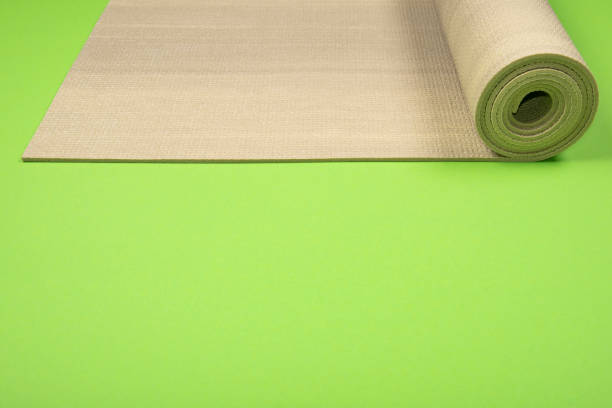 istock Yoga mat on green background with copyspace. 969538962