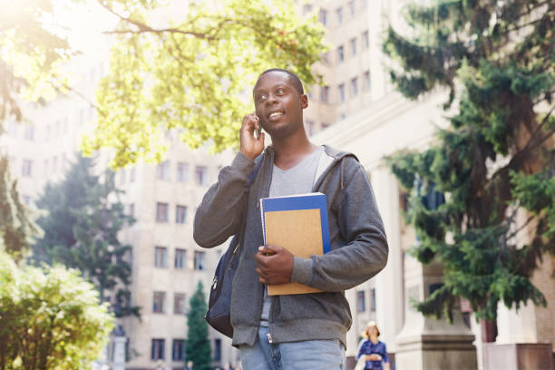 istock Young student talking on smartphone in the park 969543026