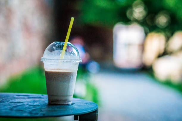 istock Smoothie drink in disposable plastic cup outdoors 969543570