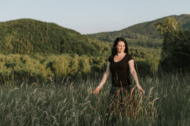 istock A woman enjoying touching grass. 969545558