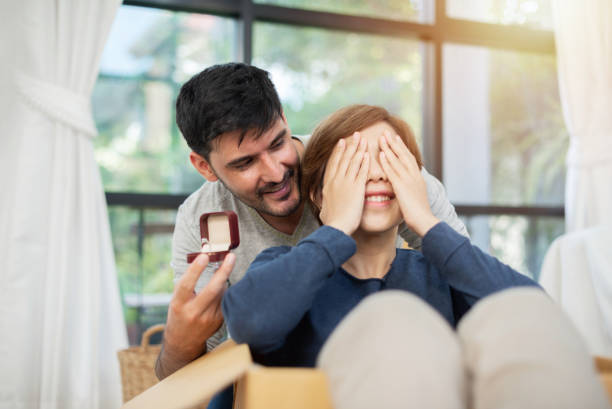 istock Young man surprising his beautiful girlfriend. 969547334